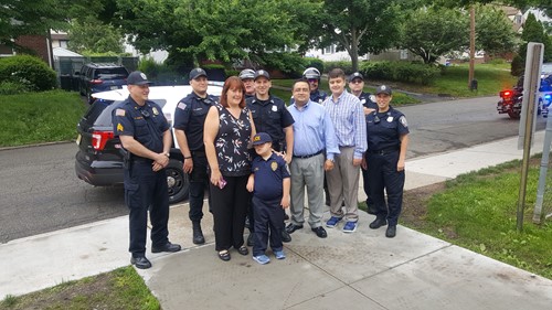 Child standing with her family and Police Officers