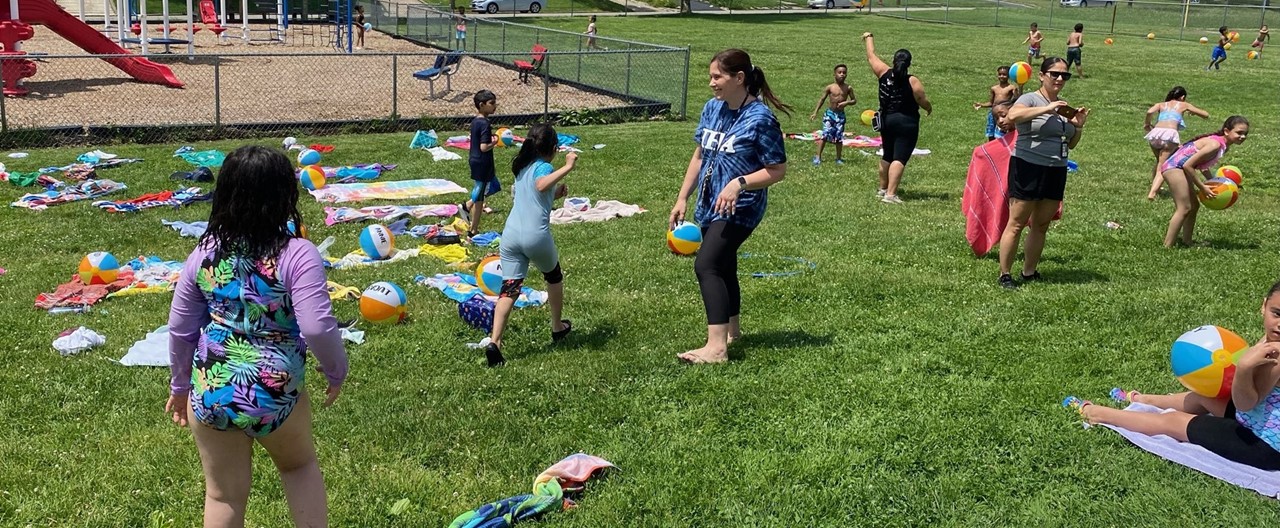 Students on a Field with Beach Towels