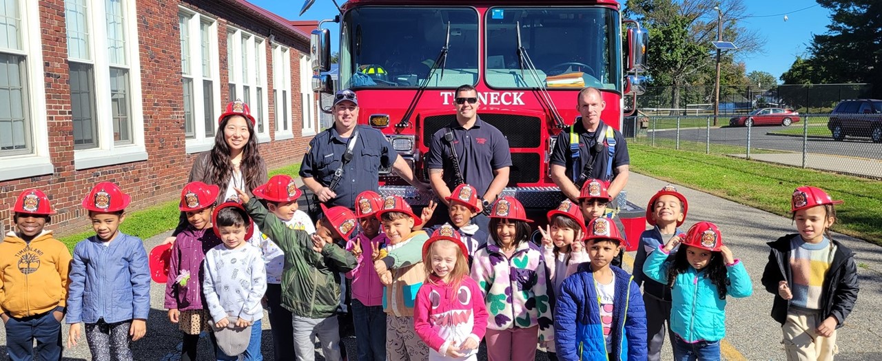 Students Standing In Front of a Fire Truck