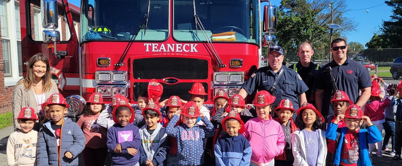Students Standing In Front of a Fire Truck