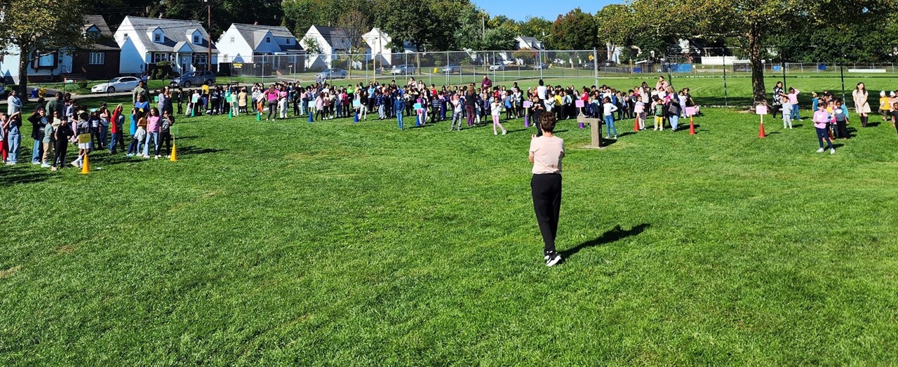 Students Standing on a Lawn