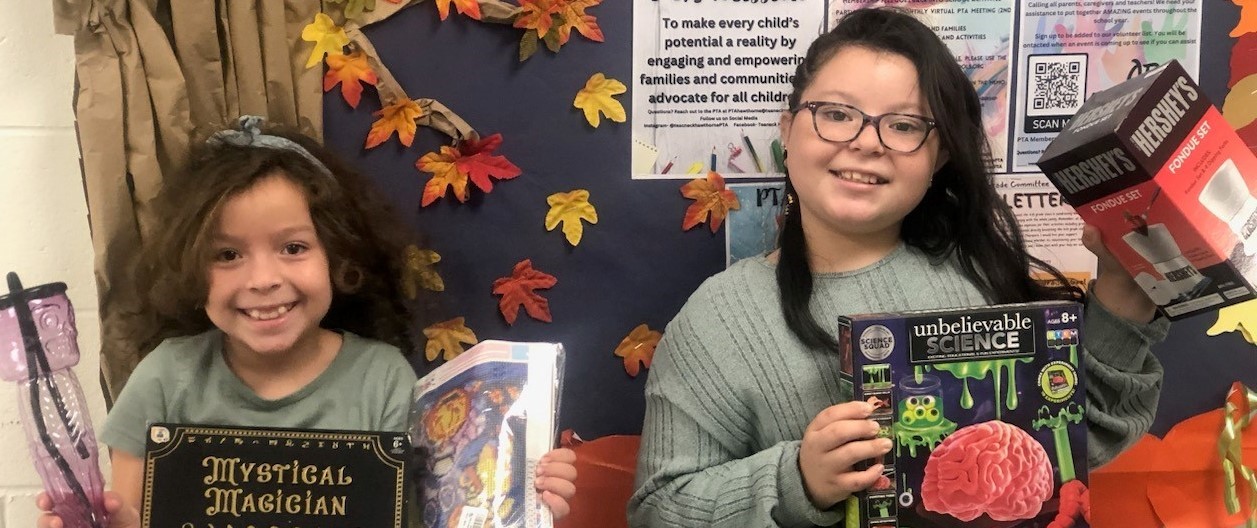 Two Girls Holding Prizes