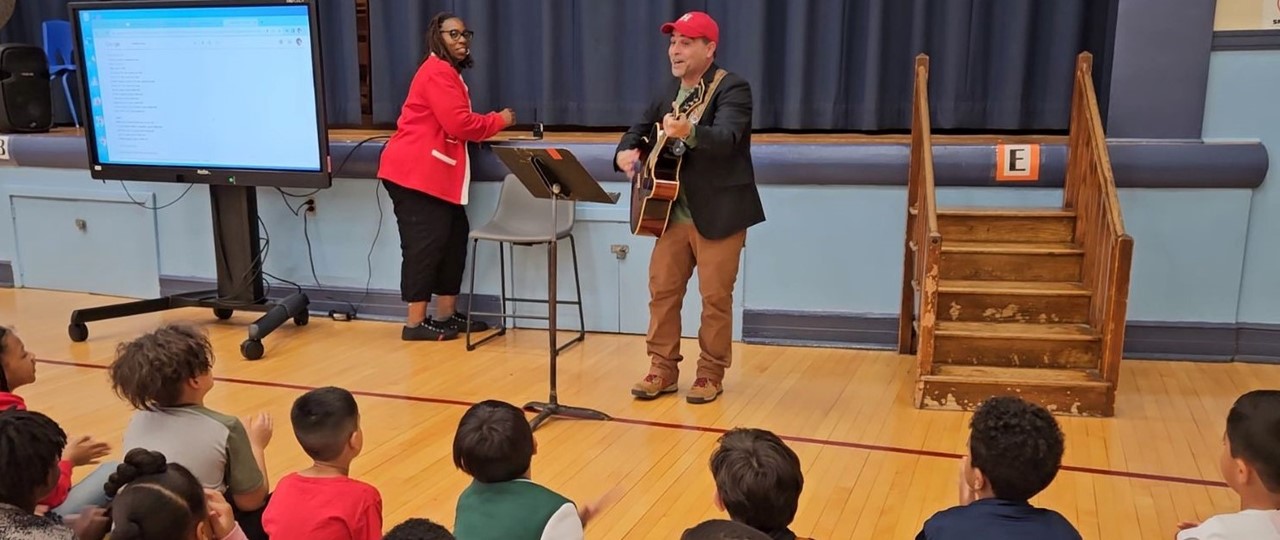 Principal Singing to Students