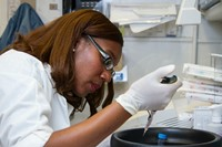 Chanelle Case Borden, Ph.D (female scientist) working in a National Cancer Institute DNA lab.